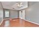 This bedroom has wood flooring, neutral walls, a ceiling fan, and double doors to the ensuite bath at 3625 Ennfield Lane Ln, Duluth, GA 30096