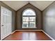 Bedroom features a high ceiling, large window, and wood flooring at 3625 Ennfield Lane Ln, Duluth, GA 30096