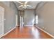 The bedroom has wood flooring, a ceiling fan, high ceilings, and an open entrance to the ensuite bathroom at 3625 Ennfield Lane Ln, Duluth, GA 30096
