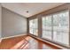 Bedroom with hardwood floors and natural light streaming through large windows at 3625 Ennfield Lane Ln, Duluth, GA 30096