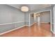 Dining room featuring a modern chandelier, wood floors and wainscoting at 3625 Ennfield Lane Ln, Duluth, GA 30096