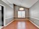 Dining room featuring a modern chandelier, wood floors and wainscoting at 3625 Ennfield Lane Ln, Duluth, GA 30096