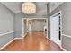 Dining room featuring a modern chandelier, wood floors and wainscoting at 3625 Ennfield Lane Ln, Duluth, GA 30096