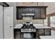 Updated kitchen featuring stainless steel appliances and dark cabinets at 3625 Ennfield Lane Ln, Duluth, GA 30096