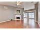 Bright living room featuring a fireplace, ceiling fan, and wood floors at 3625 Ennfield Lane Ln, Duluth, GA 30096