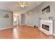 Bright living room featuring a fireplace, ceiling fan, and wood floors at 3625 Ennfield Lane Ln, Duluth, GA 30096