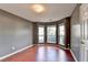 Living room featuring bay windows, wood floors, and neutral paint at 3625 Ennfield Lane Ln, Duluth, GA 30096