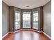 Living room featuring bay windows, wood floors, and neutral paint at 3625 Ennfield Lane Ln, Duluth, GA 30096