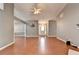 Open concept living room with wood floors, ceiling fan, and neutral paint at 3625 Ennfield Lane Ln, Duluth, GA 30096