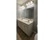 Well-lit bathroom features double sinks, vanity storage, tiled floors, and a large wall mirror at 776 Tulip Poplar Way, Lawrenceville, GA 30044