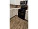 Modern kitchen with black gas range, white cabinets with modern gold pulls, and granite countertops at 776 Tulip Poplar Way, Lawrenceville, GA 30044
