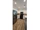 Modern kitchen with stainless steel appliances, white cabinetry, light countertops, and wood-look tile flooring at 776 Tulip Poplar Way, Lawrenceville, GA 30044