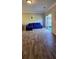Living room featuring stylish hardwood floors, sliding glass doors to the backyard, and modern decor at 776 Tulip Poplar Way, Lawrenceville, GA 30044