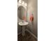Chic powder room featuring a pedestal sink, modern mirror, and wood-look tile flooring at 776 Tulip Poplar Way, Lawrenceville, GA 30044