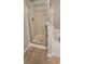 Bathroom featuring tile flooring and a tub/shower combination with glass door at 776 Tulip Poplar Way, Lawrenceville, GA 30044