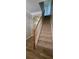 Carpeted staircase with wood railing and newel post, showcasing modern interior design at 776 Tulip Poplar Way, Lawrenceville, GA 30044