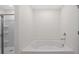 Bathroom with a white tub and shower stall at 8587 Secretariat Dr, Lithonia, GA 30058