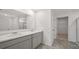 Bathroom showcasing double vanity with gray cabinets and modern fixtures at 8587 Secretariat Dr, Lithonia, GA 30058