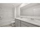 Bathroom features a double vanity, marble countertops and backsplash, and shower over tub at 8587 Secretariat Dr, Lithonia, GA 30058