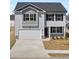 Charming two-story home featuring a two-car garage and classic architectural details at 8587 Secretariat Dr, Lithonia, GA 30058