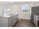Bright kitchen featuring stainless appliances, granite counters, island and backyard access through patio doors at 8587 Secretariat Dr, Lithonia, GA 30058
