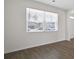 Comfortable living room showcasing wood floors, ample natural light, and a view of the neighborhood at 8587 Secretariat Dr, Lithonia, GA 30058