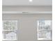 Living room featuring bright, neutral walls and a pair of large windows at 8587 Secretariat Dr, Lithonia, GA 30058
