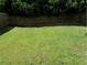 The large, well-maintained backyard is surrounded by a wooden fence and mature trees at 857 Asbury Trl, Lithonia, GA 30058