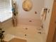 Bright bathroom with a large white bathtub, tiled wall, and decor at 857 Asbury Trl, Lithonia, GA 30058