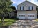 Charming two-story home with an attached two car garage and well-maintained lawn at 857 Asbury Trl, Lithonia, GA 30058