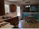 Bright kitchen with wood cabinets, tiled floors, and a stainless steel dishwasher at 857 Asbury Trl, Lithonia, GA 30058