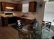 Cozy kitchen featuring wood cabinetry, white countertops, and stainless steel appliances at 857 Asbury Trl, Lithonia, GA 30058