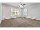 Large bedroom with neutral carpet, two windows for natural light, and a ceiling fan at 3170 Cedar Glade Ln, Buford, GA 30519
