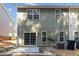 Rear exterior with sliding glass doors to a patio, and well-maintained siding on a sunny day at 3170 Cedar Glade Ln, Buford, GA 30519