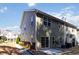 The back of the townhome boasts siding, a patio, sliding glass doors, and mature landscaping at 3170 Cedar Glade Ln, Buford, GA 30519