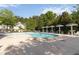 Inviting community pool area with sun umbrellas, seating, and lush greenery, perfect for relaxation at 3170 Cedar Glade Ln, Buford, GA 30519