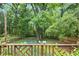 Backyard view from deck with a lush lawn, mature trees, and a privacy fence at 1091 Napier St, Atlanta, GA 30316