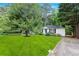 Charming single-story home featuring a well-manicured lawn, mature trees, and a classic white exterior at 1091 Napier St, Atlanta, GA 30316
