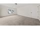 A secondary bedroom has neutral carpet and white doors and a window looking out on the neighborhood at 179 Hunters Crk, Dallas, GA 30157