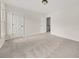 A secondary bedroom has neutral carpet and white doors, one open to a staircase at 179 Hunters Crk, Dallas, GA 30157