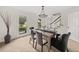 Bright dining room features modern lighting, neutral paint, and natural light from nearby windows at 179 Hunters Crk, Dallas, GA 30157