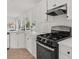 Modern kitchen featuring white cabinets, stainless steel appliances and ample natural light at 179 Hunters Crk, Dallas, GA 30157