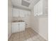 Convenient laundry room with white cabinets and a stainless steel sink at 179 Hunters Crk, Dallas, GA 30157