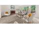 Bright living room featuring a brick fireplace, large windows and plush carpeting at 179 Hunters Crk, Dallas, GA 30157