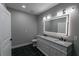 Bathroom featuring granite countertops, an illuminated mirror, and stylish fixtures at 1174 Donnelly Sw Ave, Atlanta, GA 30310