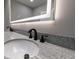 Bathroom vanity featuring dual sinks, modern faucets, and a granite countertop at 1174 Donnelly Sw Ave, Atlanta, GA 30310