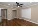 Bedroom featuring hardwood floors, white trim, large windows, and ceiling fan at 1174 Donnelly Sw Ave, Atlanta, GA 30310