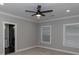 Bedroom features natural light, ensuite bathroom, and modern ceiling fan at 1174 Donnelly Sw Ave, Atlanta, GA 30310