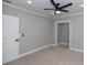 This bedroom features neutral carpeting and a ceiling fan for comfort at 1174 Donnelly Sw Ave, Atlanta, GA 30310