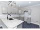 Modern kitchen featuring gray cabinets, granite countertops, black hardware and dark tile flooring at 1174 Donnelly Sw Ave, Atlanta, GA 30310